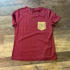 Heathered Maroon T-shirt with gold sequin pocket.